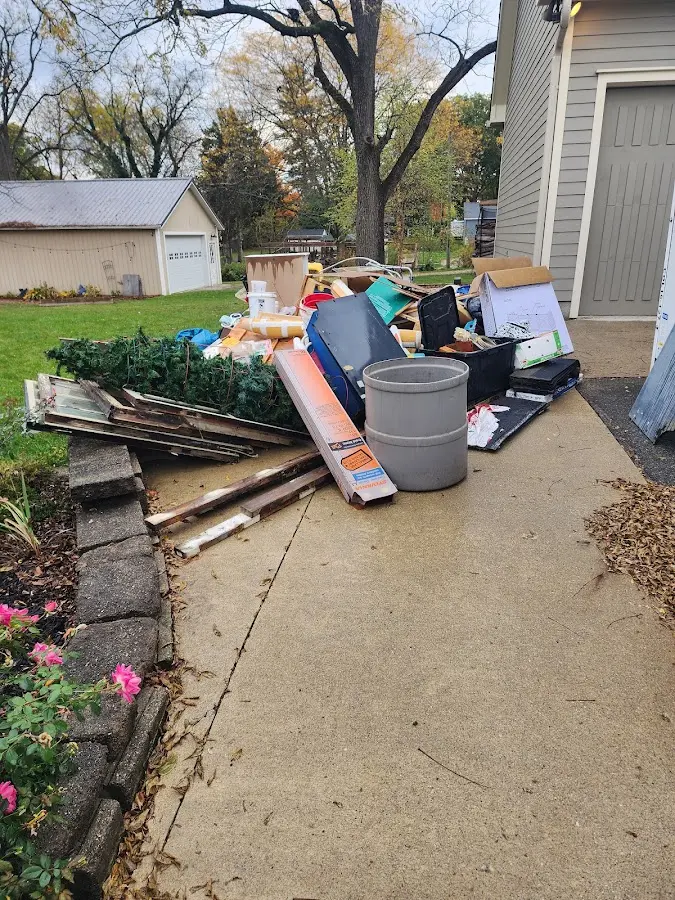 Dumpster being loaded with debris for Estate Cleanout Dumpster Rental in Ponca City